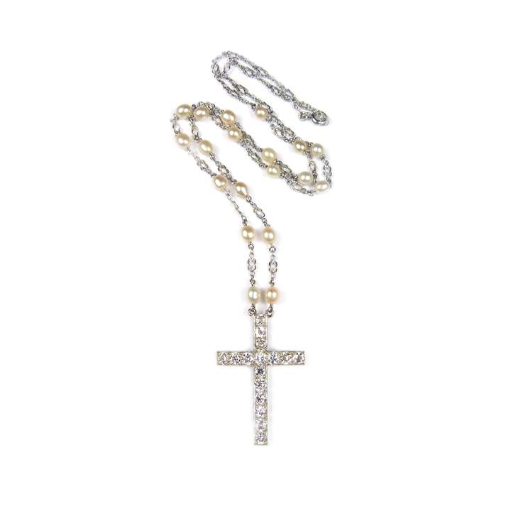 Early 20th century diamond cross pendant on a pearl set platinum chain necklace